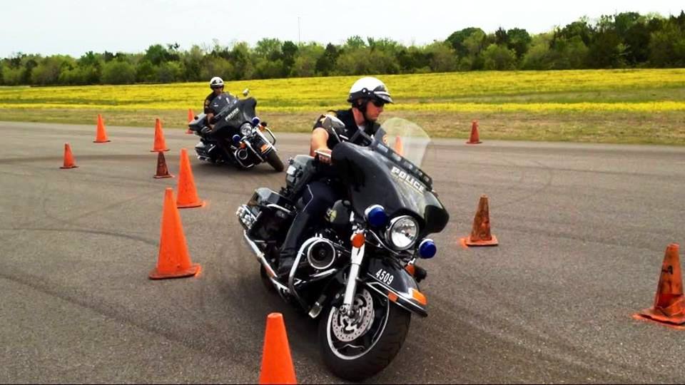 MPD Motorcycle officers riding through a cone course.